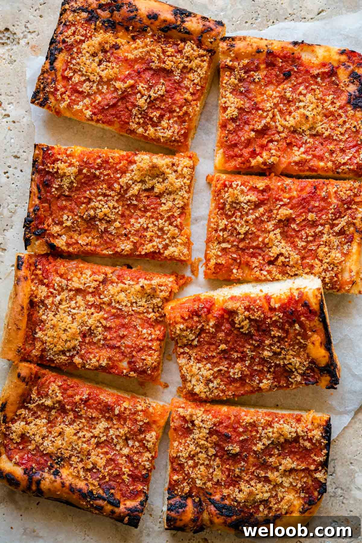 An overhead shot of Sfincione pizza cut into slices