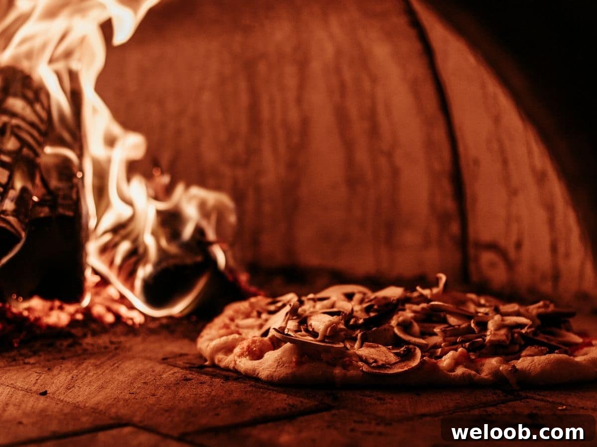 A pizza inside a wood fired pizza oven