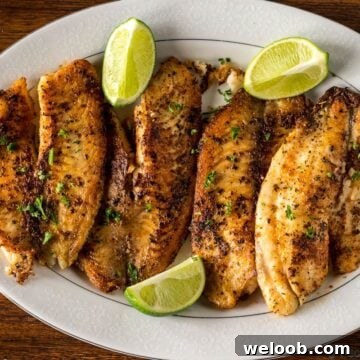 Pan Seared Tilapia on a serving tray with lime wedges