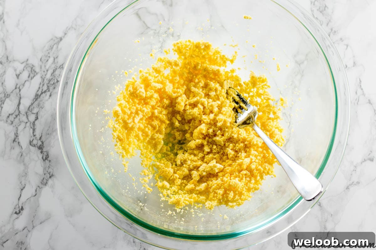 Mashing egg yolks for deviled eggs