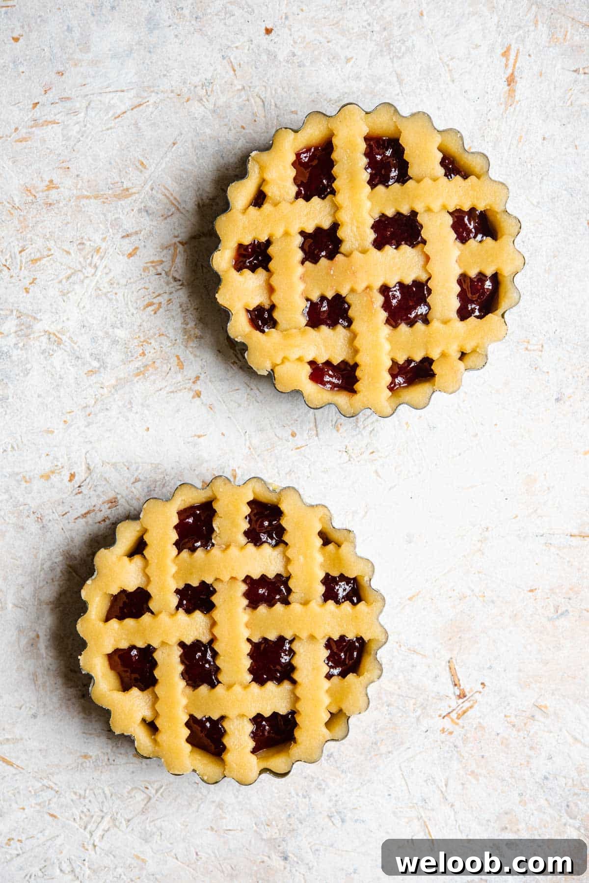 An overhead shot of two shortcrust pastry tarts before being cooked