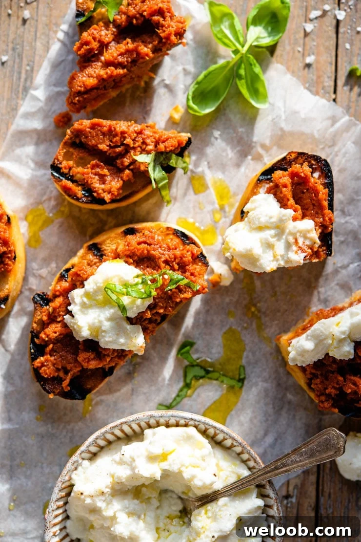 An overhead shot of red pesto on ciabatta bread with ricotta