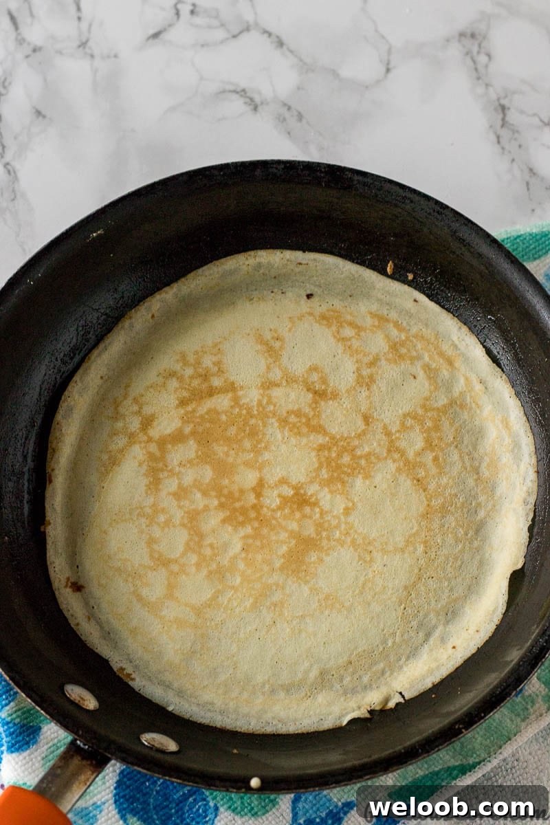Perfect French Crepes: Thin, Tender, and Ready in Minutes 7 A crepe on a skillet