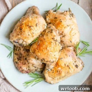 A square image of baked chicken thighs on a plate
