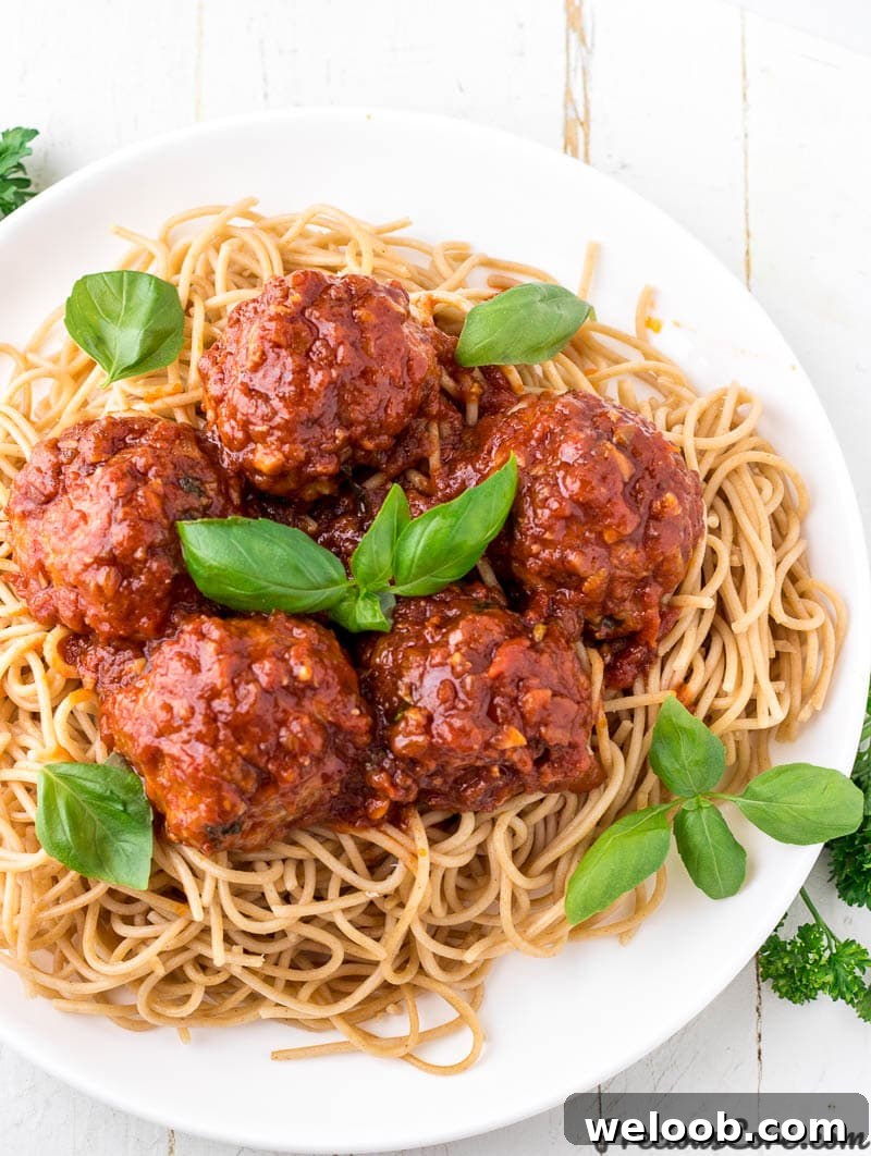 Juicy Baked Chicken Meatballs with Garlic Parmesan Sauce 2 Chicken meatballs served over spaghetti.
