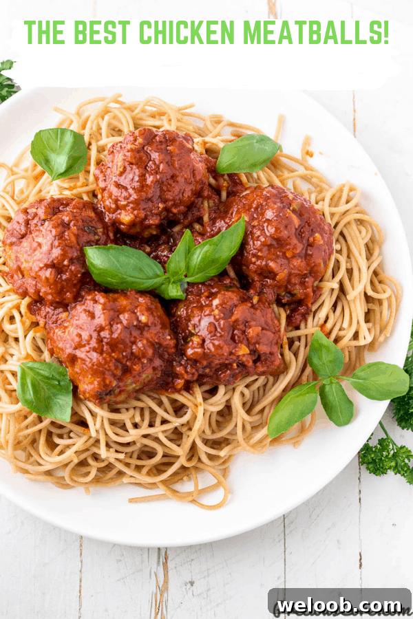 Juicy Baked Chicken Meatballs with Garlic Parmesan Sauce 7 Picture of meatballs on spaghetti