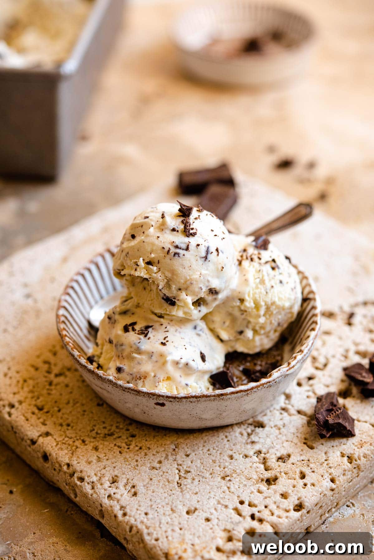 A close up of three scoops of ice cream in a rustic dish
