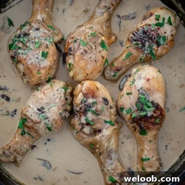 Chicken drumsticks in creamy sauce in a cast iron skillet