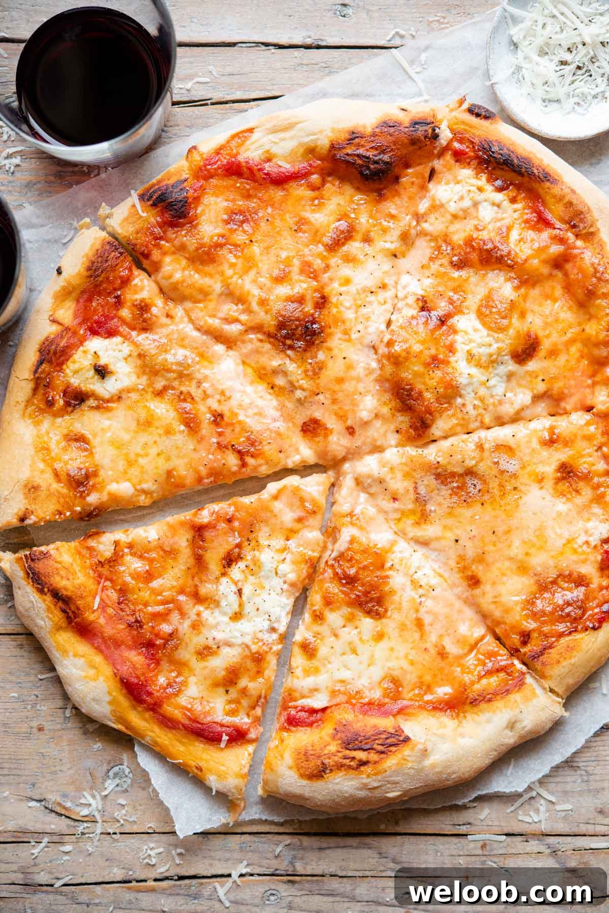 An overhead shot of a four cheese pizza (quattro formaggi) cut into slices