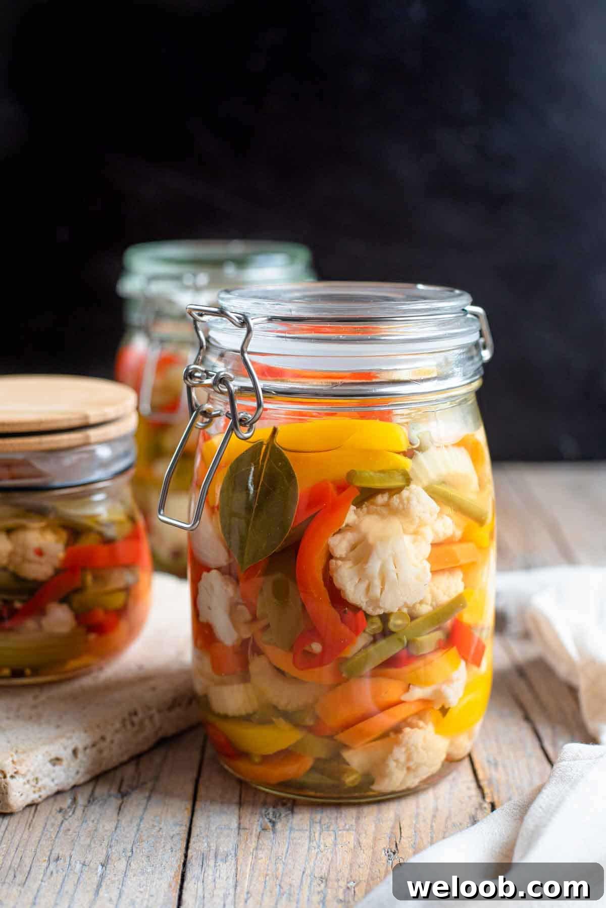 A close up of Giardiniera pickled vegetables in a glass jar