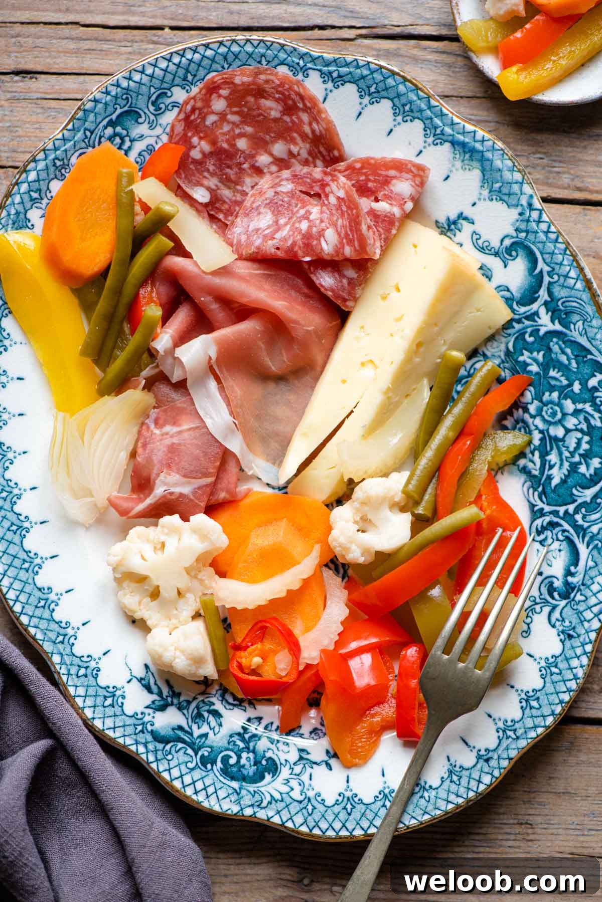 Italian pickled vegetables on a platter with cured meats and cheese