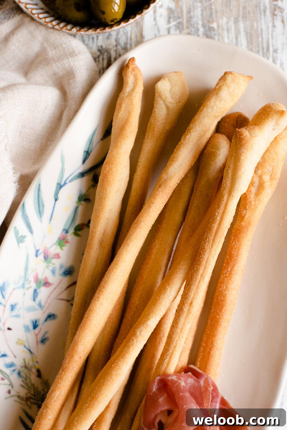 A close up of Italian Grissini breadsticks on a serving plate