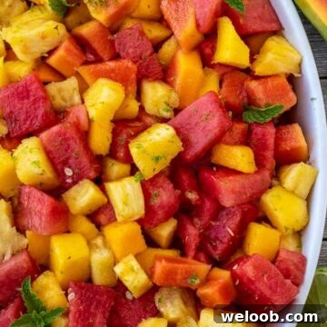 Tropical fruit salad in a serving bowl.