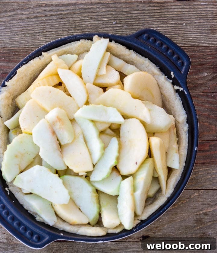 apple pie uncooked filling in baked crust