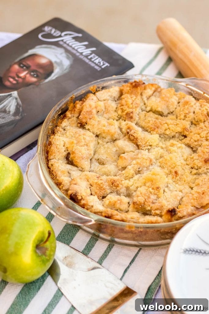 Apple Pie on table with apples and pie spoon
