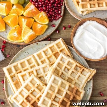 Homemade Waffles on a plate with whipped cream on the side