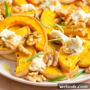 A close up of roasted butternut squash and gorgonzola on a serving plate