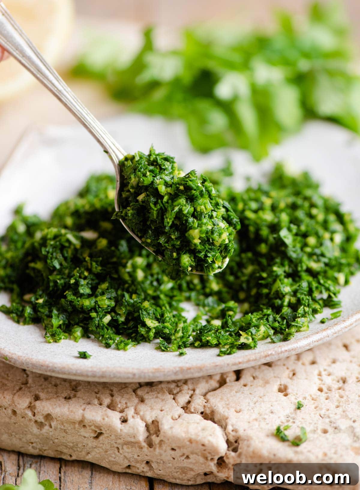 A close up of gremolata on a spoon