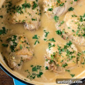 Chicken in White Sauce in a cast iron braiser.