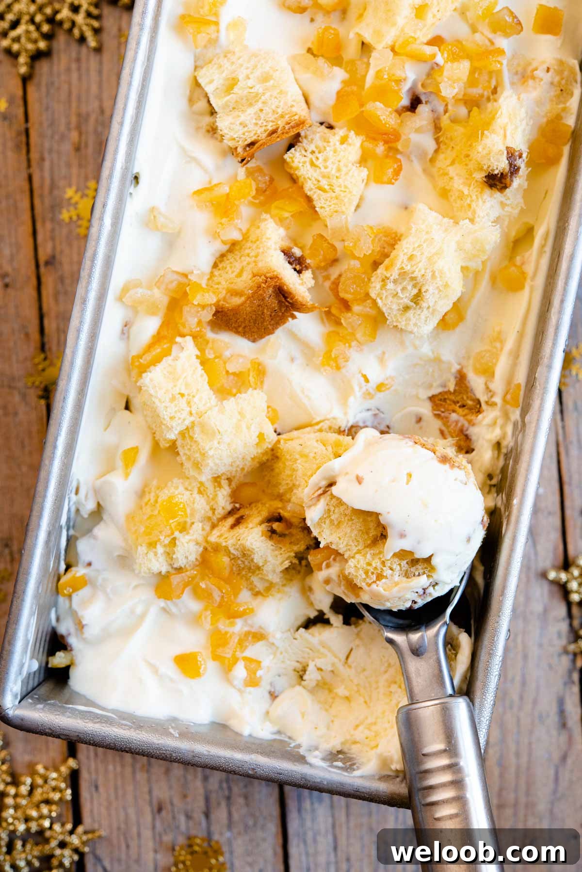 A close up of panettone ice cream in an ice cream scoop