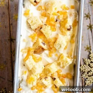 An overhead shot of panettone ice cream in a loaf tin topped with candied peel