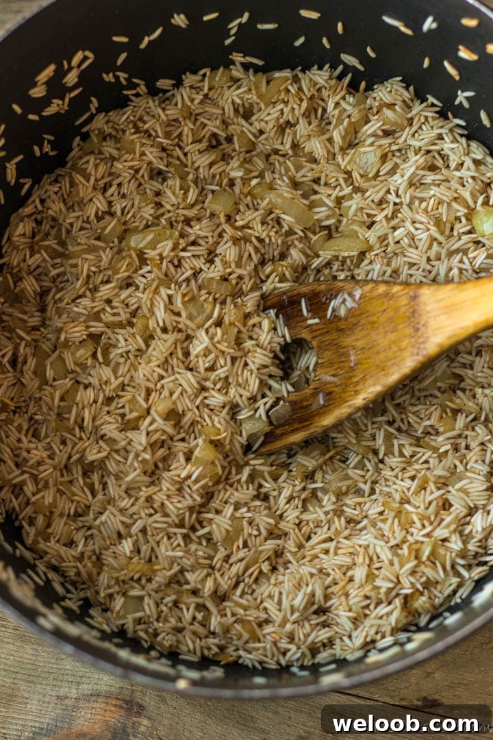 Rice, sauteed onion and oil in a pot.