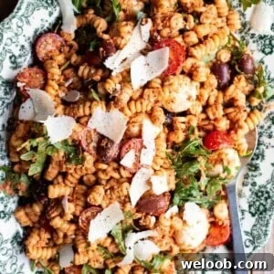 A close up of sun-dried tomato pasta fredda on a serving plate.