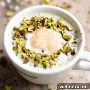 Pistachio Affogato Recipe: Creamy Pistachio Gelato with Espresso 5 A close up cropped image of a pistachio affogato in a white mug.