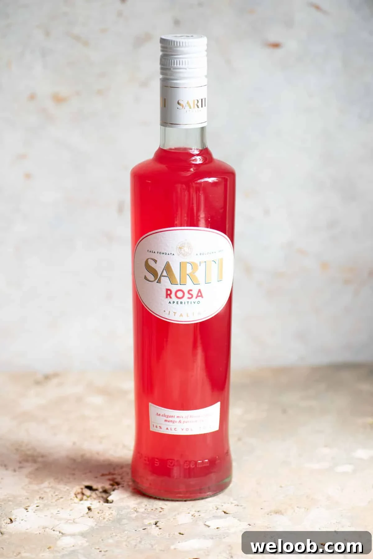 A bottle of Sarti liqueur on a neutral background.