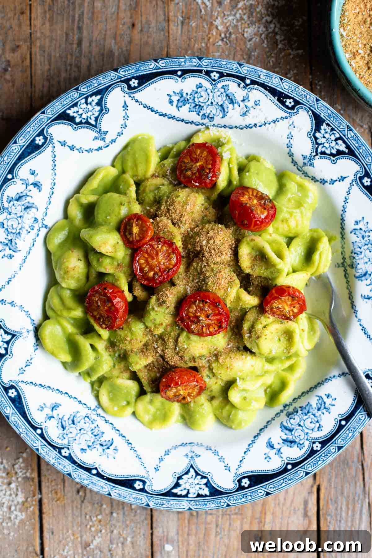 Orecchiette with Zucchini, Brown Butter and Roasted Tomatoes 2 An overhead shot of orecchiette pasta in a vibrant green zucchini sauce with roasted cherry tomatoes on top.