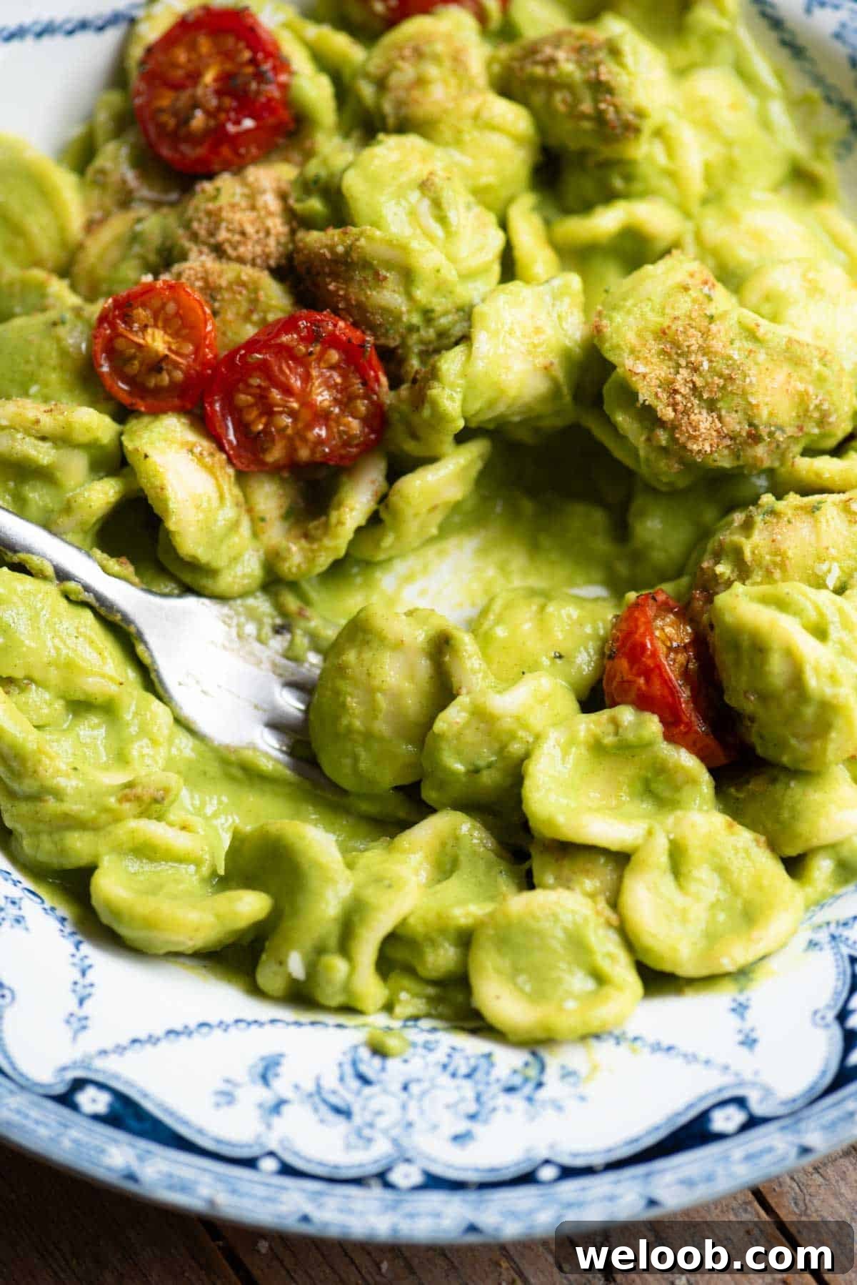 Orecchiette with Zucchini, Brown Butter and Roasted Tomatoes 4 A close up of orecchiette in a smooth vibrant green zucchini sauce with roasted tomatoes on top.
