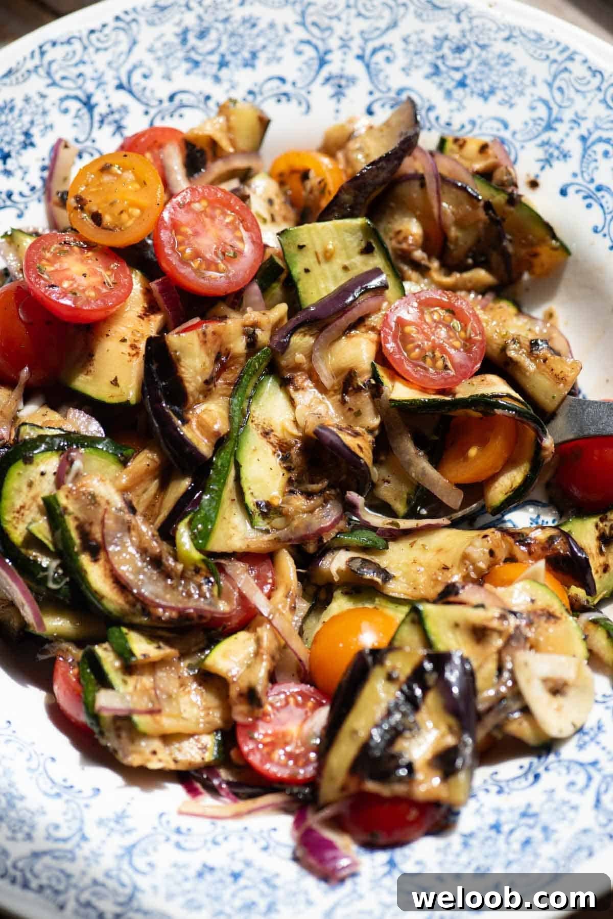 A close up of marinated grilled vegetables in a bowl.