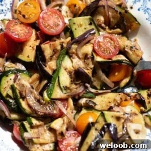 A close up of marinated summer vegetables in a bowl.