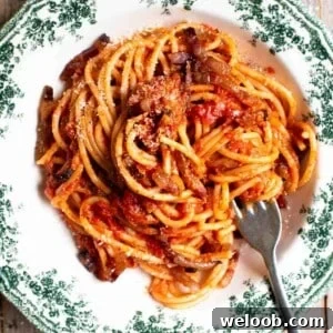 A close up cropped image of past al rancetto with tomato, pancetta and onion.