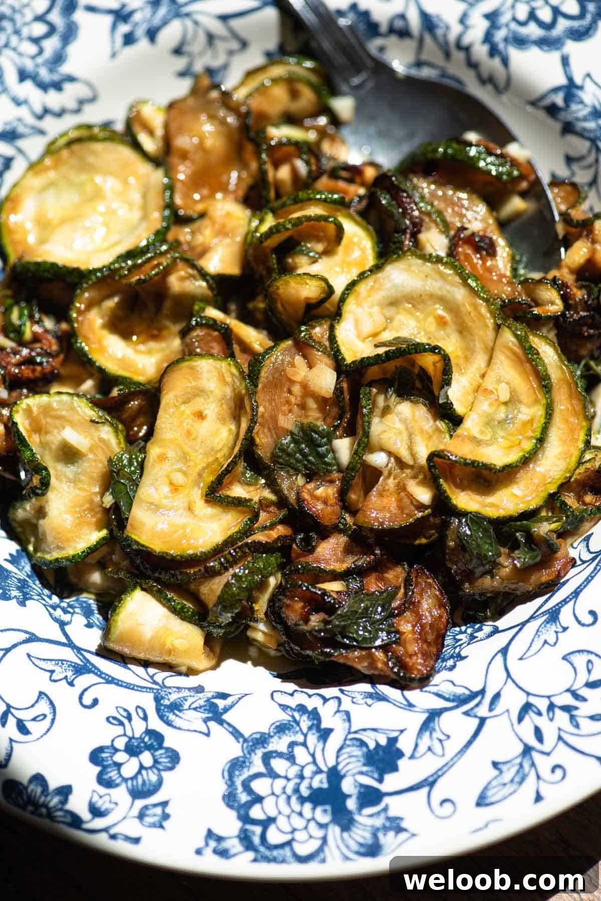 Zucchine alla Scapece: Neapolitan Marinated Zucchini 4 A close up of fried marinated zucchini in a blue bowl.