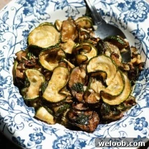 Zucchine alla Scapece: Neapolitan Marinated Zucchini 9 A cropped close up image of fried zucchini in a blue and white bowl.