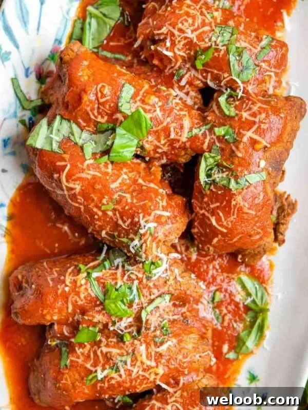 Beef Tramezzino with Radicchio, Cheese and Porchetta 8 An overhead shot of beef braciole on a platter with tomato sauce
