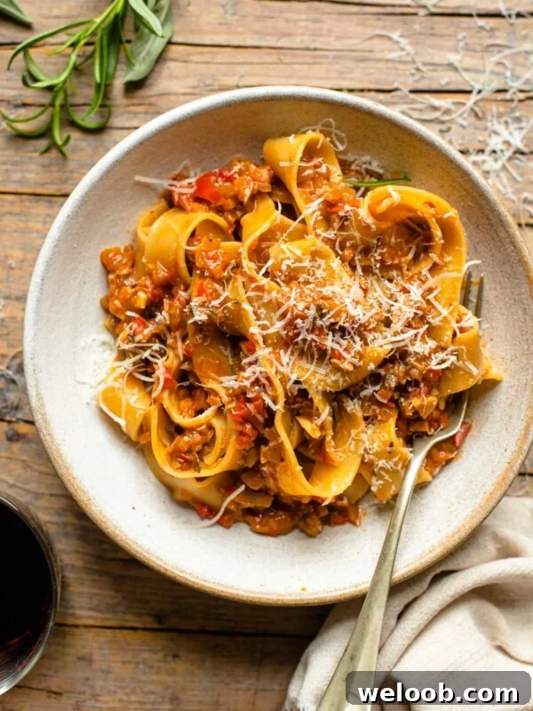 An overhead shot of a bowl of pasta on a wooden surface