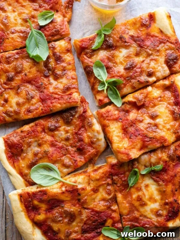 Mediterranean Olive, Anchovy and Caper Pizza with Oregano 6 An overgead shot of a focaccia pizza cut into slices
