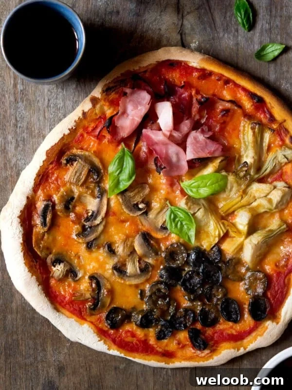 Mediterranean Olive, Anchovy and Caper Pizza with Oregano 8 AN overhead shot of a four seasons pizza
