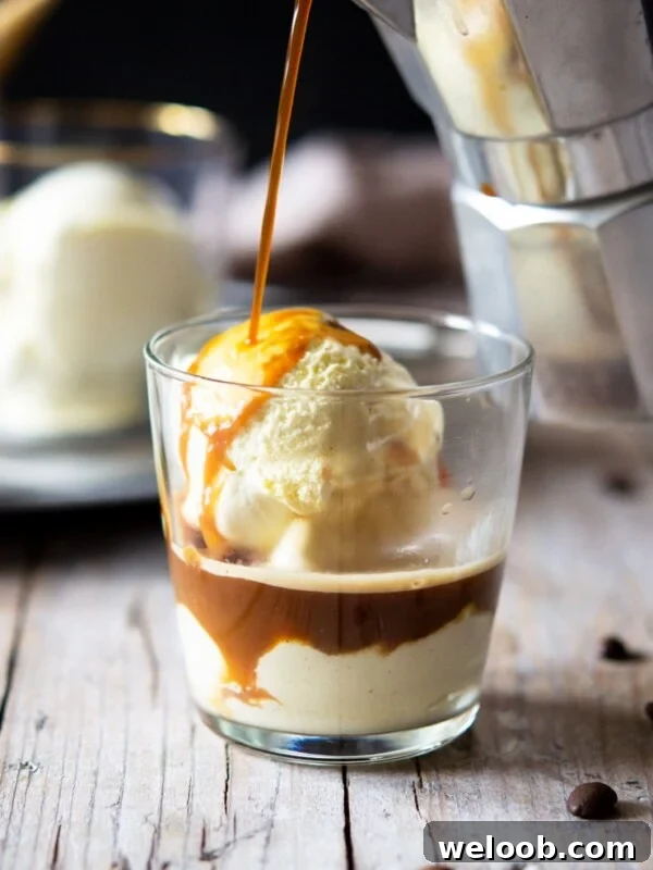 A photo of coffee getting poured over ice cream in a glass to make an affogato