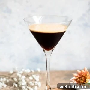 A close up of a cocktail glass filled with an iced coffee.