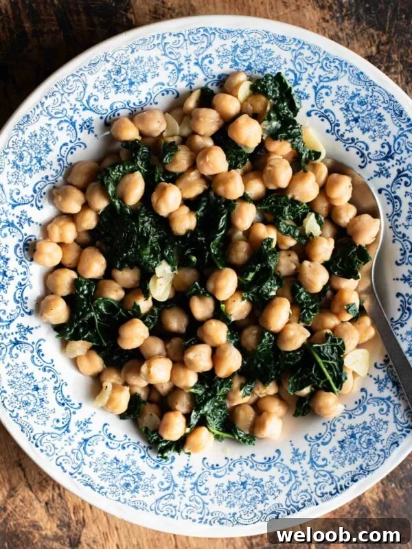 How to Make Italian Marinated Roasted Bell Peppers 8 Chickpeas with garlic and cavolo nero in a blue and white bowl sitting on a rustic wooden surface.